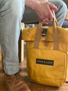 man-holding-love-is-love-backpack