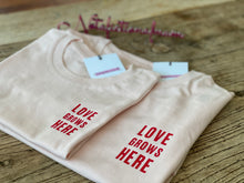 Load image into Gallery viewer, cream-matching-tshirts-love-grows-here-slogan-in-red
