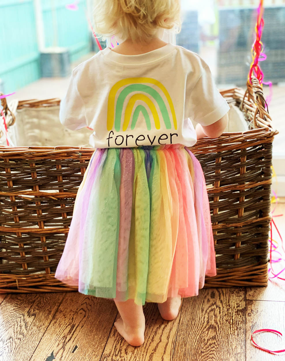 Child-wearing-forever-white-tshirt-rainbow-tuttu