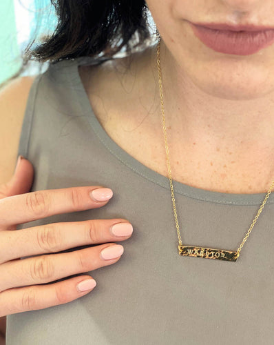 woman-wearing-gold-hammered-bar-necklace