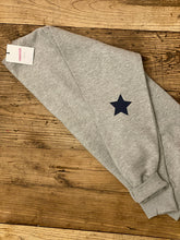 Load image into Gallery viewer, folded-grey-sweatshirt-with-grey-star-on-elbow
