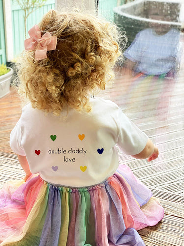 girl-wearing-double-daddy-love-kids-LGBTQ+-tshirt-with-rainbow-hearts-tuttu-one-of-the-items-from-the-adoption-clothing-range-from-notafictionalmum;