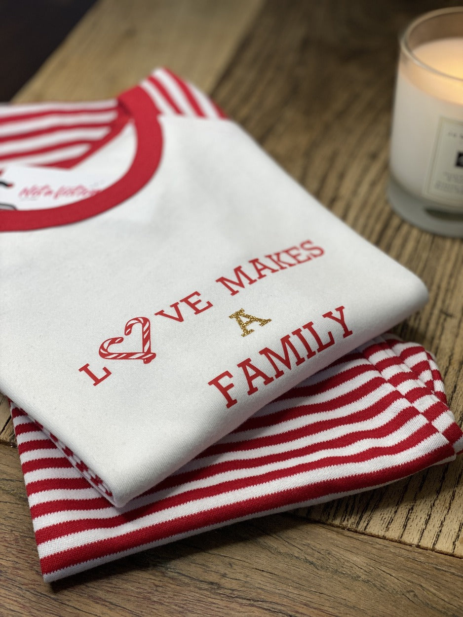 matching-family-christmas-pyjamas-wooden-table-scented-candle