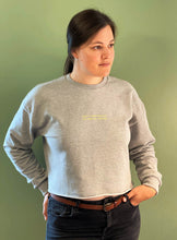 Load image into Gallery viewer, woman-wearing-grey-marl-sweatshirt-with-slogan-dont-interrupt-me-im-family-finding-green-backdrop
