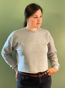 woman-wearing-grey-marl-sweatshirt-with-slogan-dont-interrupt-me-im-family-finding-green-backdrop